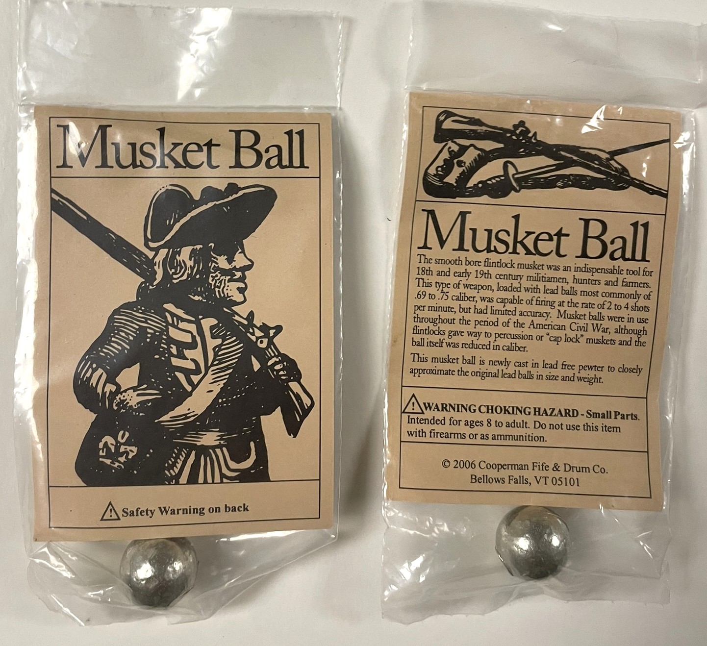 Two packages of pewter musket balls with illustrated 18th-century labels